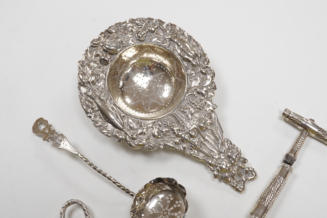 Small silver and white metal, including an Edwardian silver tea strainer, import marks for London, 1908, 15.7cm, a late Victorian silver sifter spoon, silver handled scissors with case, a white metal corkscrew and a whit